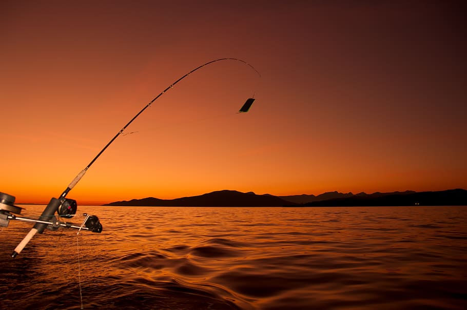 Fishing From Boat While Sunset